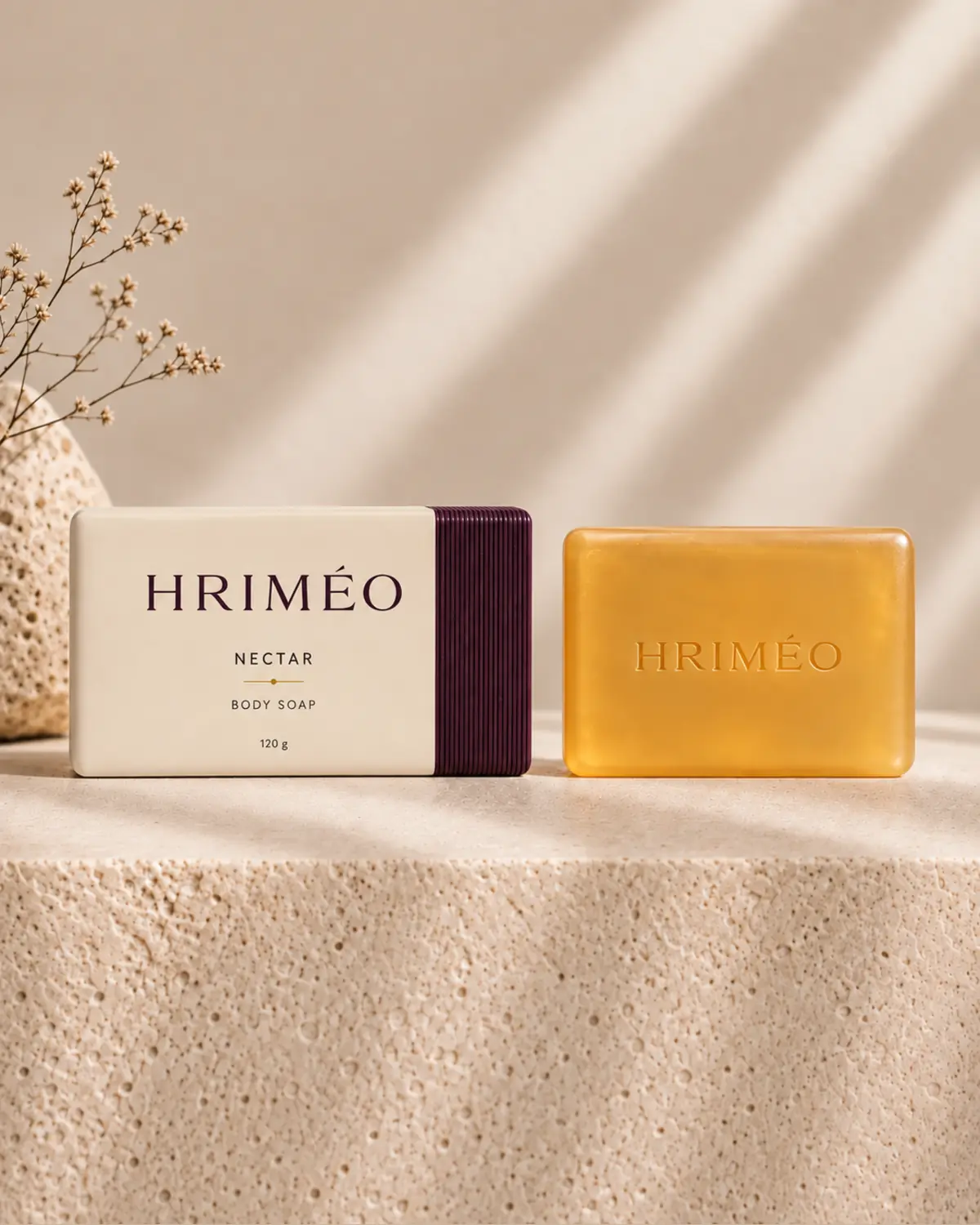 HRIMÉO Golden Nectar Body Soap as a honey-gold bar beside its warm beige carton with aubergine ribbed detail
