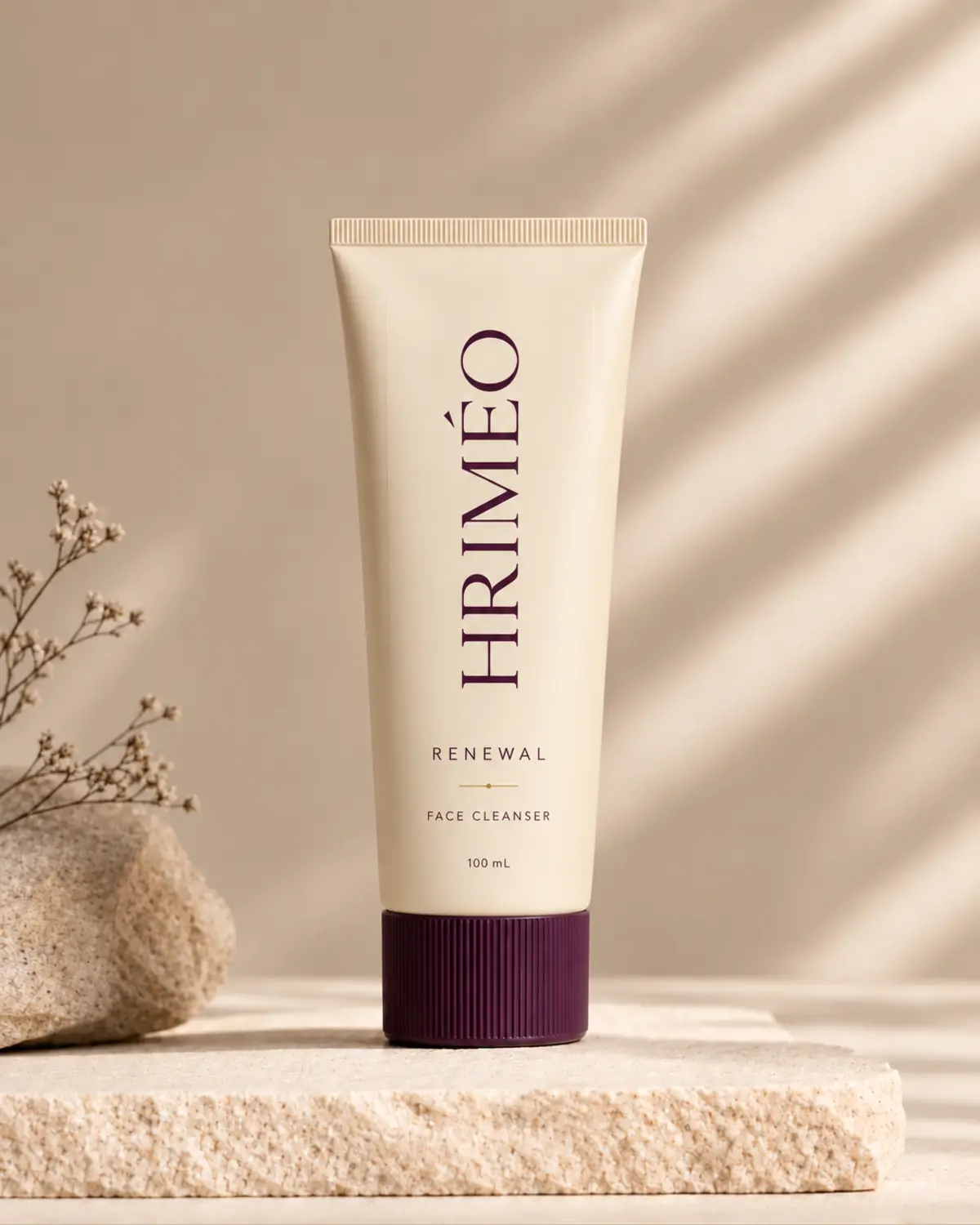 HRIMÉO Renewal Face Cleanser in a warm beige tube with an aubergine ribbed cap